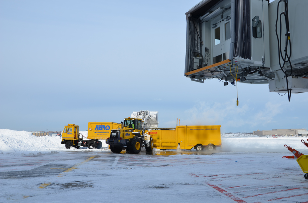 Snow Loader Dumping Snow into a Snow Melter