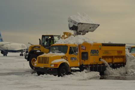 Loading Snow Into a Dump Truck at an Airport