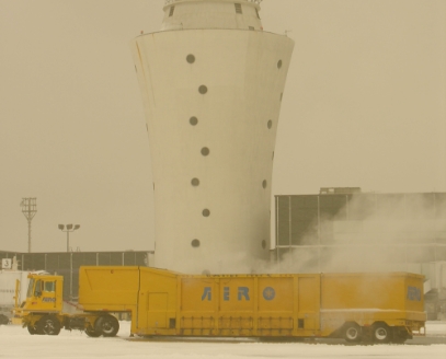 Aero Snow Melter in front of an Airport Control Tower